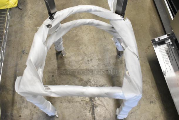 Gray metal dining chair frame, new with scratch and dent. Cross back design. Partially wrapped. Auction for 3 chairs.
