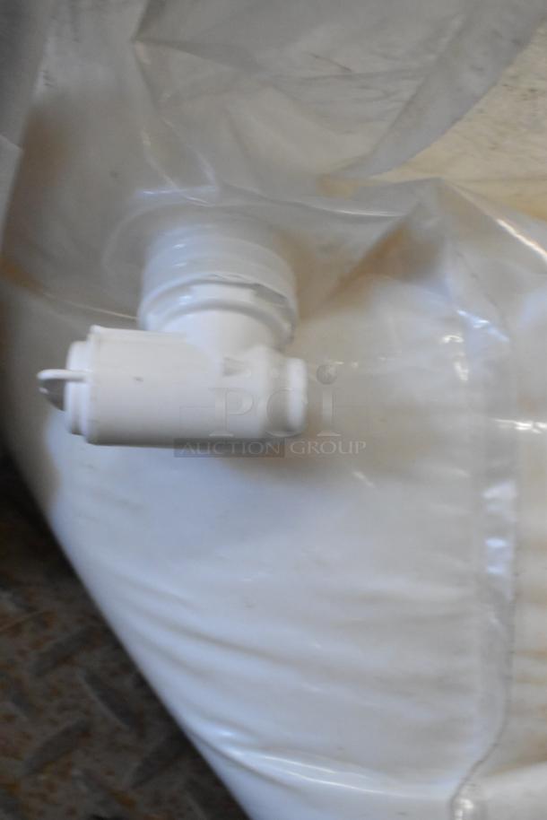 Heavy-duty plastic bag with a white spout, likely a bulk container for liquid hand soap.