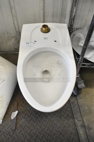 American Standard toilet bowl, white, missing tank. Label indicates auction item 77. Clean, no visible damage.
