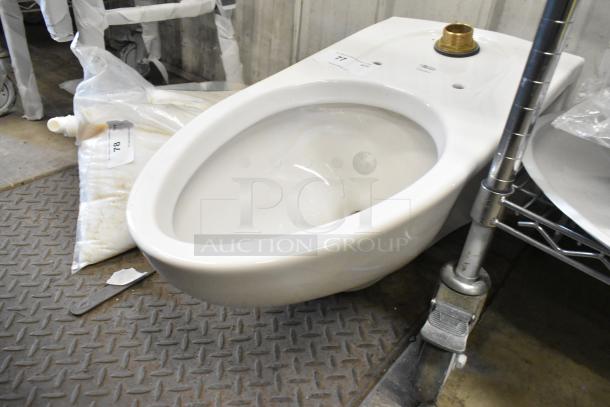 American Standard toilet without tank, in excellent condition, shown indoors with visible mounting holes and brass inlet.