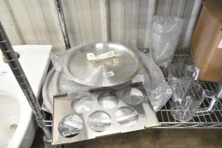 Brand new 471SPC20 aluminum pot cover, poly pitchers, and various items on a metal shelf. Tags indicate model and details.