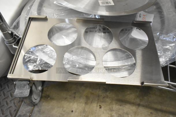 9 new scratch and dent items, including a 12 5/8" aluminum pot/pan cover and poly pitchers, auctioned as is.