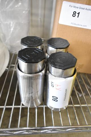 Lot of 4 metal legs, 5 inches tall, chrome finish, black rubber tops, new condition. Label indicates auction lot number 81.