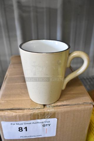 Box of 12 brand new Acopa ceramic mugs, cream with speckled design, shown with one mug on top. Perfect condition, ready for use.