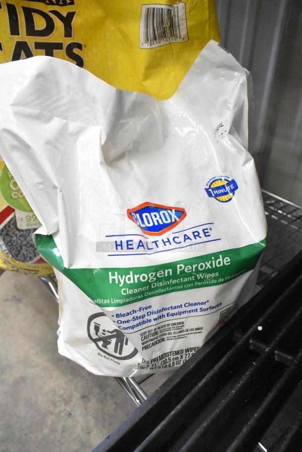 Clorox Hydrogen Peroxide Cleaning Wipes bag in front of Purina Tidy Cats Litter bag. Clean and sealed packaging.