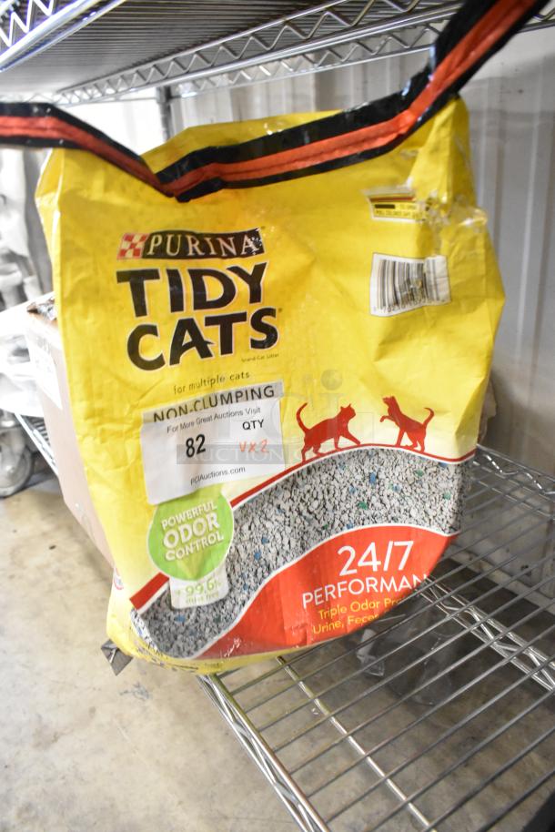 Purina Tidy Cats Litter bag, powerful odor control, visible label "82" with auction details, non-clumping formula.