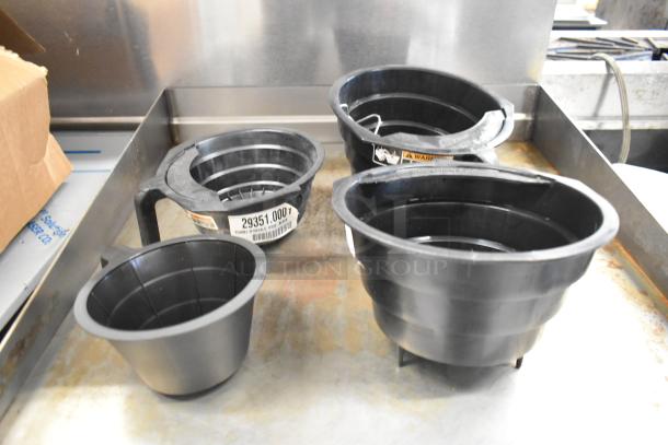 Four black poly brew baskets, varying sizes, lightly used. Visible labels show "29351.0007" and safety warnings.