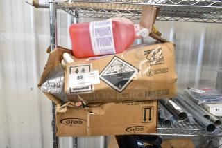 Three Diversey cleaning items including Stride Citrus Cleaner and Pro Strip Floor Stripper on a metal shelf, with damaged packaging.