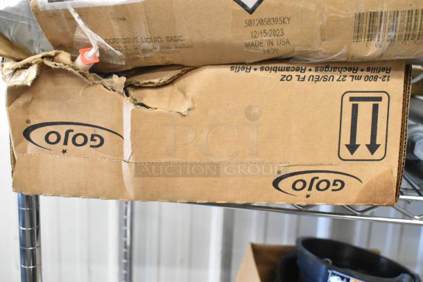 Cardboard box with visible wear, marked "Corrosive Liquid, Basic." Contains Diversey cleaning products, made in USA.