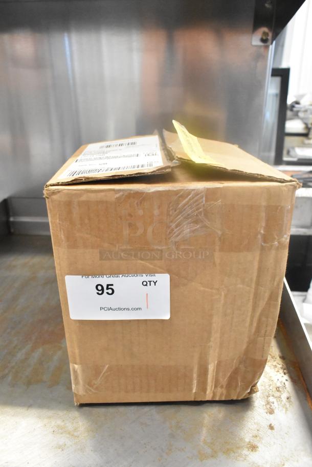 Cardboard box labeled "95 QTY" containing black lids, visible shipping label, slightly worn condition.