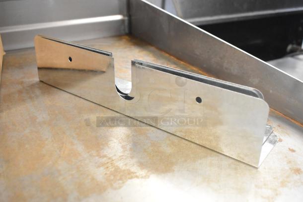 Box of shiny metal pieces, featuring cutouts and holes, suitable for industrial or construction use. Good condition.