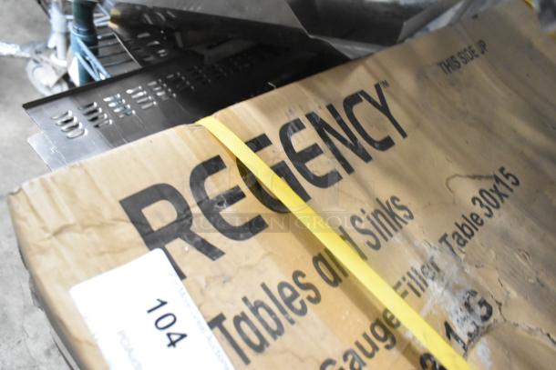 BRAND NEW SCRATCH AND DENT Regency 600TB3036G stainless steel work table with backsplash, shown in packaging.