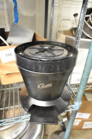 Curtis black poly countertop stand, used, with branding visible on the front, sturdy design, minor wear.