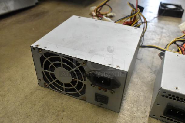 AT-265SFX Power Supply, features fan and connector ports, in used condition with visible wear, suitable for computer use.