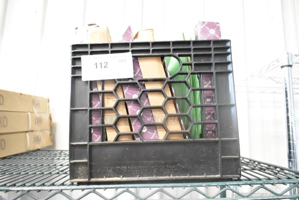 Five boxes of assorted folders in a black crate. Visible label: Lot 112, quantity indications. Ideal for bulk purchase.