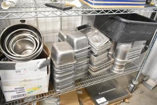 Tiered lot of stainless steel drop-in bins, stacked on metal shelving. Includes various sizes, used condition.