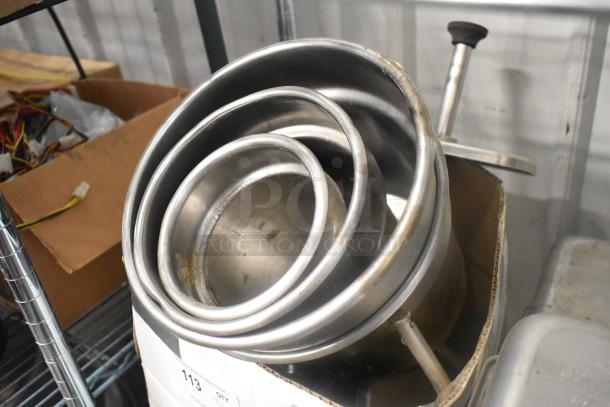 A lot featuring stainless steel drop-in bins, varying sizes, used condition, stacked in a cardboard box.