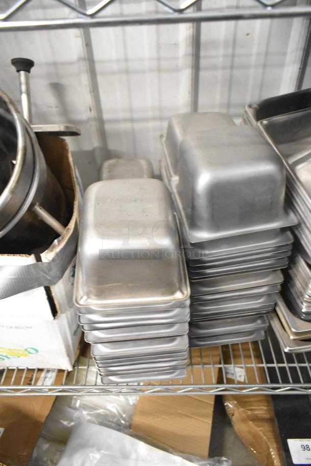 Stainless steel drop-in bins on a shelf, part of a mixed auction lot, stacked neatly, in good condition.
