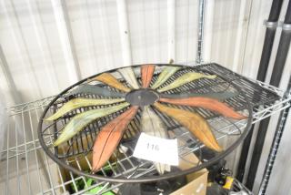 Colorful metal wall decoration with leaf pattern on wire rack. Auction label reads "116".