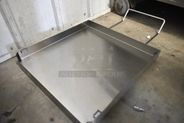 Stainless steel panel, reflective surface, slight signs of wear, triangular marking. Suitable for industrial use.
