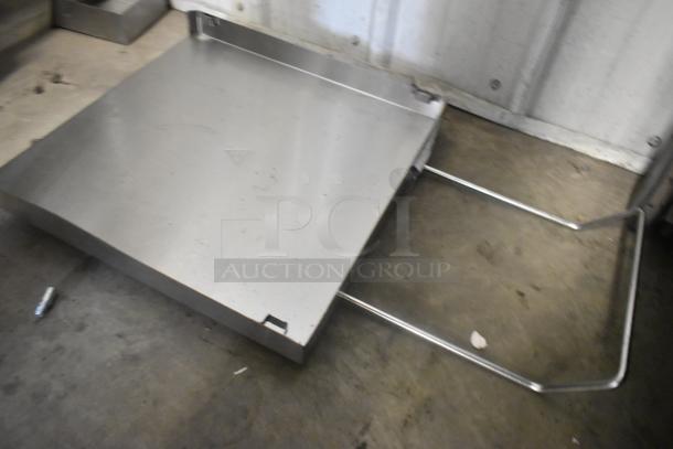 Stainless steel panel, rectangular shape, smooth finish, metal supports, slight wear marks, industrial use.