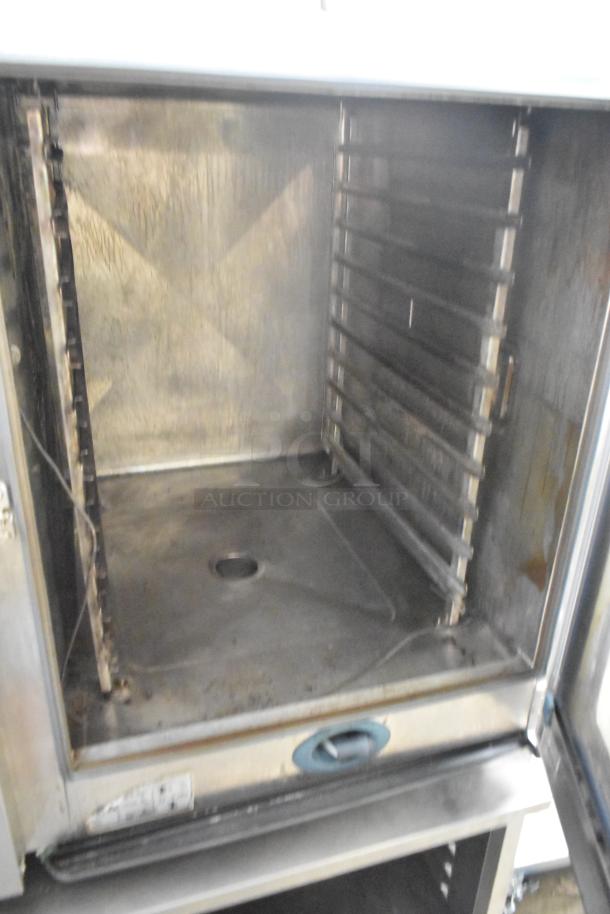 Rational stainless steel commercial combi convection oven on equipment stand, natural gas powered, visible wear and interior racks.