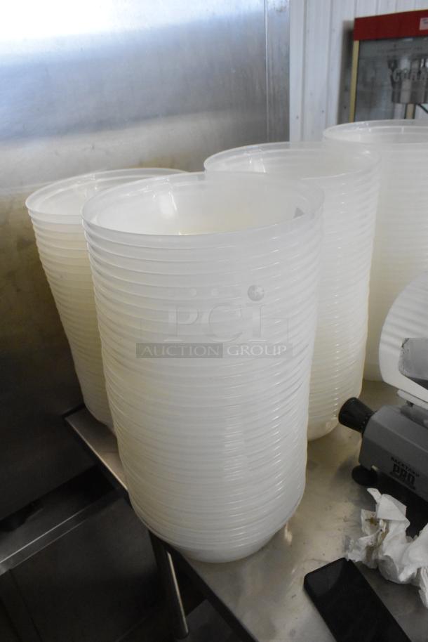 Lot of translucent poly dome covers stacked, in excellent condition, ideal for various containment purposes.
