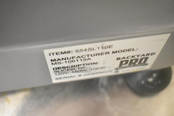 Backyard Pro 554SL110E meat slicer with blade sharpener, stainless steel, 115V, 1 Phase. Model label with specs visible.