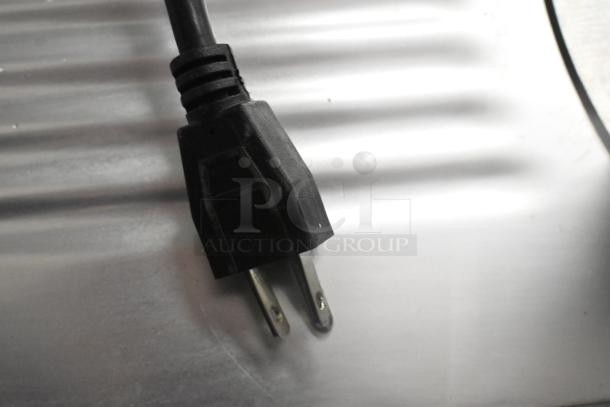 Power plug for Backyard Pro 554SL110E Commercial Meat Slicer on stainless steel surface. 115 Volts, 1 Phase.