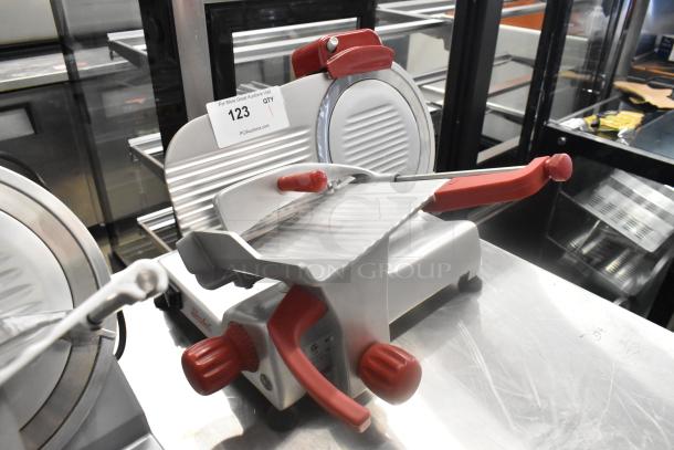 2023 Berkel B9-SLC stainless steel meat slicer with blade sharpener, red controls, and voltage label visible.