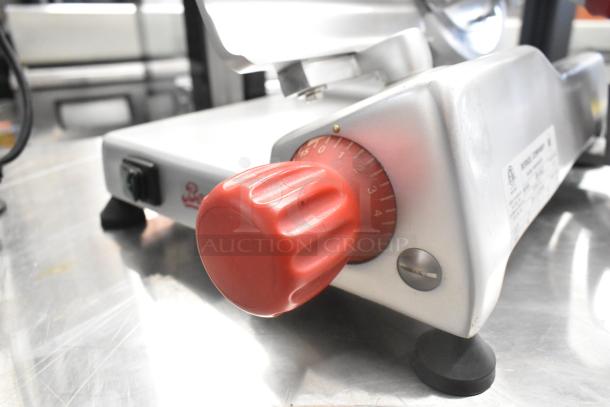 2023 Berkel B9-SLC meat slicer with red knob; stainless steel, built-in blade sharpener, 115V, 1 phase, excellent condition.