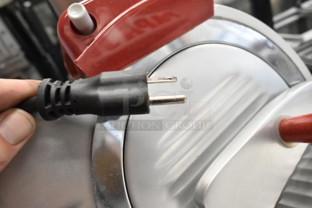 2023 Berkel B9-SLC stainless steel meat slicer with blade sharpener, 115V plug visible, commercial countertop model.