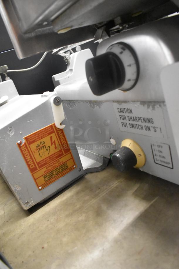 Bizerba A330 stainless steel commercial meat slicer with control knobs and caution labels, 120 volts, 1 phase.