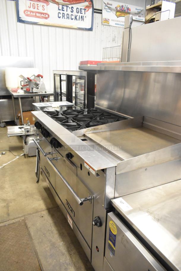 Vulcan 60SS-6B24GTN stainless steel commercial range with 6 burners, flat top griddle, 2 ovens, overshelf, and backsplash.