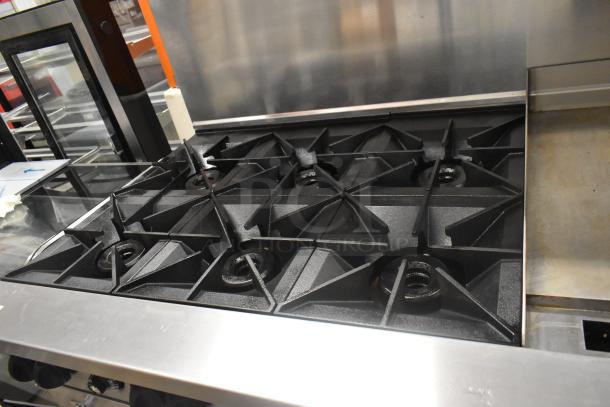Vulcan 60SS-6B24GTN stainless steel 6-burner range with flat top griddle, dual ovens, over shelf, back splash, on casters.