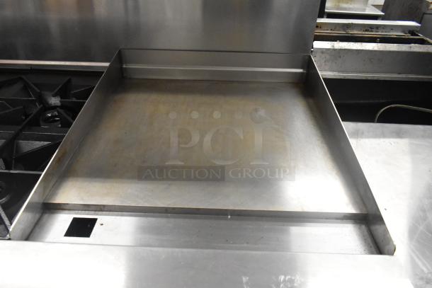 Vulcan 60SS-6B24GTN commercial stainless steel 6 burner range, flat top griddle, in used condition. Features over shelf, back splash.
