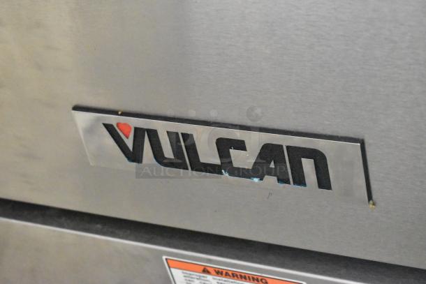 Vulcan 60SS-6B24GTN stainless steel commercial range with 6 burners, griddle, 2 ovens, overshelf, backsplash, on casters.