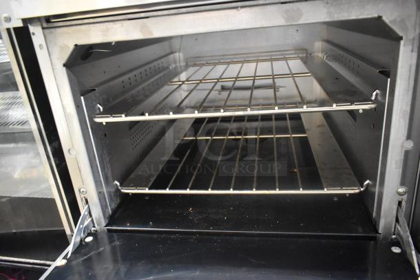 Interior of Vulcan 60SS-6B24GTN oven showing two metal racks, stainless steel finish, and clean condition.