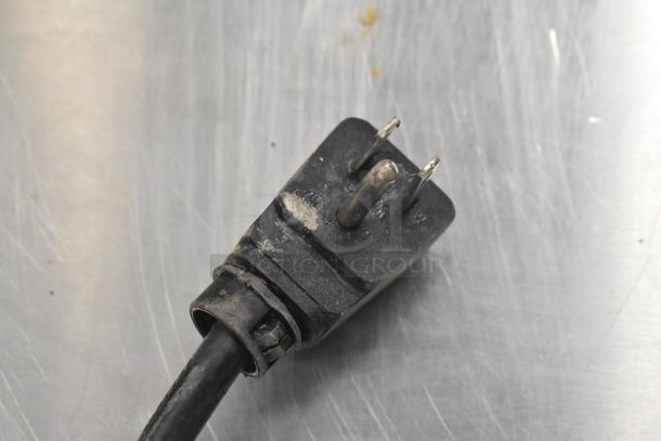 Power plug of an Everest ETSSR2-D2 stainless steel commercial cooler. Slight wear visible on the plug surface.