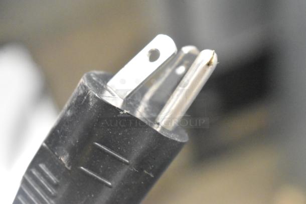 Close-up of a standard power plug for the Cornelius WCC700-A ice maker, indicating electrical compatibility.