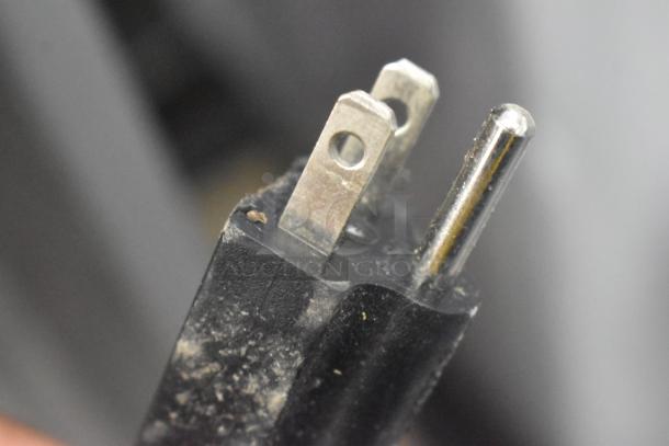 Close-up of a three-pronged plug with some dust present. The image relates to the Avantco 177VB205 broiler listing. No visible tags or labels.