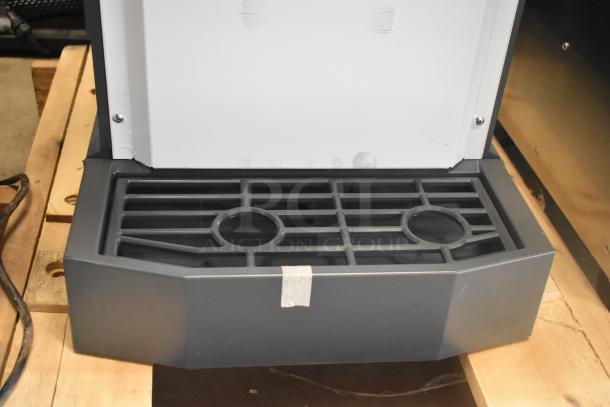 Brand new Scotsman HID312AB-1A stainless steel countertop ice machine base with dispensing area, showing minor dents.