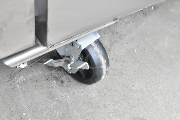 BRAND NEW Avantco 178Z1F2A Stainless Steel 2 Half Size Door Reach In Freezer, 115V, caster wheel detail. Scratch and dent.