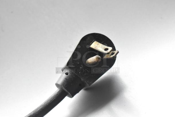 Black power plug end of a Silver King SK5MAJ milk dispenser. Image focuses on plug prongs, showing detail and condition.