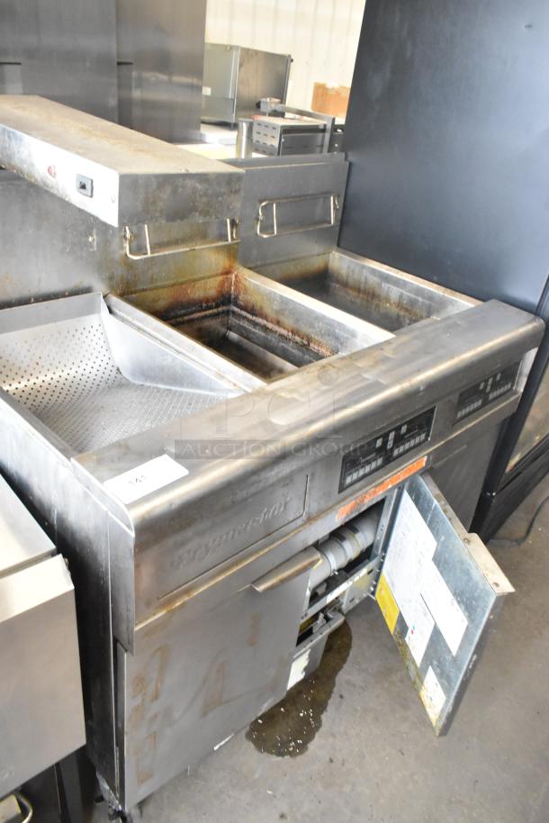 Frymaster FMPH255CSC stainless steel 2-bay deep fat fryer with dumping station, commercial casters, visible wear.