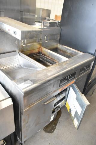 Frymaster FMPH255CSC stainless steel 2-bay deep fat fryer with dumping station, commercial casters, visible wear.