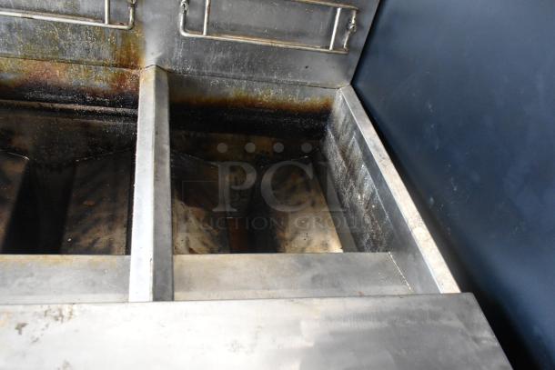 Frymaster FMPH255CSC 2-bay gas fryer with dumping station, stainless steel, on casters. Shows signs of use. 80,000 BTU.