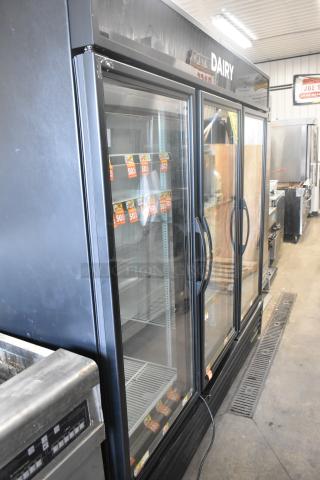 2016 True GDM-72-HC commercial cooler, 3 glass doors, poly-coated racks, standard 115V, 1 phase, dairy signage visible.