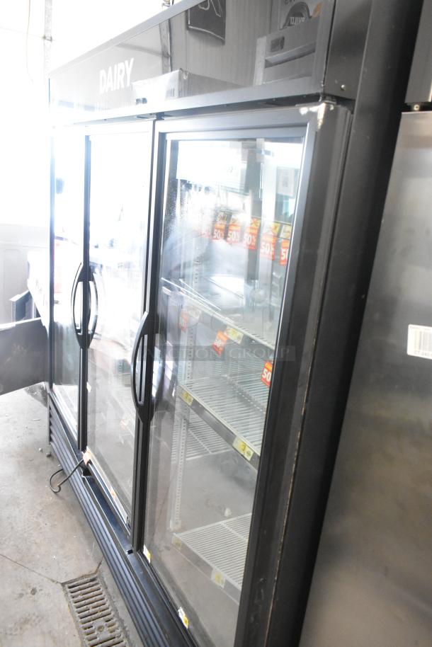 2016 True GDM-72-HC commercial 3-door merchandiser cooler with poly coated racks, 115V, 1 phase, in good condition.