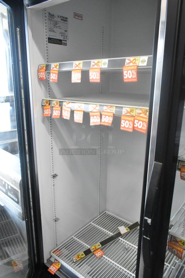 2016 True GDM-72-HC commercial 3-door cooler with poly coated racks, 115V, 1 phase. Visible clearance tags.